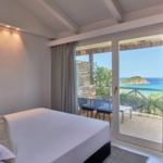 Baia di Chia Resort Sardinia_King Deluxe Room with Sea View _Bedroom - Baia di Chia Resort, Curio Collection by Hilton